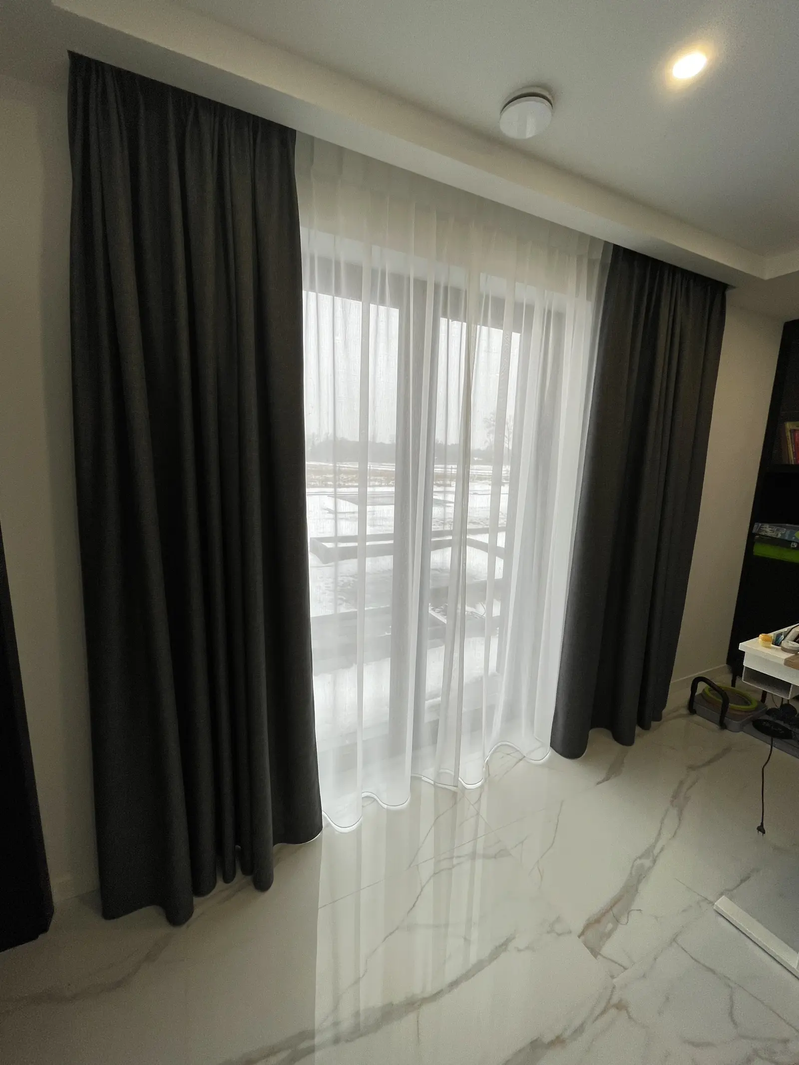 Pokój z ciemnymi zasłonami i białymi firanami na szynie sufitowej — Łódź